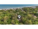 Aerial view of a coastal home nestled among lush trees with ocean views, offering privacy and serenity at 206 Dogwood Dr., Myrtle Beach, SC 29575