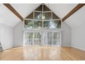 Bright living room featuring soaring windows, hardwood floors, and a vaulted ceiling with exposed beams at 206 Dogwood Dr., Myrtle Beach, SC 29575