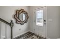 Bright foyer features wood-look flooring, an entry door with glass and a decorative mirror at 264 Bolsin Ct, Conway, SC 29526
