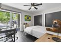 Bright bedroom with sleek, dark floors, modern décor, and a large window view at 306 Salt Marsh Circle # 5A, Pawleys Island, SC 29585