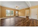 Open living room featuring hardwood floors, a ceiling fan, and plenty of natural light at 3565 Steamer Trace Rd., Conway, SC 29527