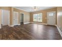 Bright living room boasts hardwood floors, a ceiling fan, and a view of the front yard at 3565 Steamer Trace Rd., Conway, SC 29527