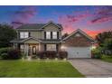 Exterior view of a two-story home at dusk with brick and vinyl siding at 3605 Kingsley Dr., Myrtle Beach, SC 29588