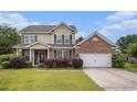 Two-story home with brick and vinyl siding, well-maintained lawn and two-car garage at 3605 Kingsley Dr., Myrtle Beach, SC 29588