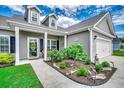 Inviting home exterior with colorful flowers in the garden, leading to a charming covered entrance at 364 Copperwood Loop, Conway, SC 29526