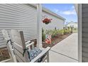 Relaxing porch seating with decorative floral arrangements and a charming water feature at 4027 Taranto Loop # C, Myrtle Beach, SC 29579