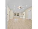 Bright living room featuring modern flooring, fresh paint, and a stylish ceiling fan at 409 14Th Ave. S, North Myrtle Beach, SC 29582