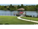 Scenic view of a well-maintained backyard featuring a boat dock and lift on the serene waterfront at 4110 Gray Heron Dr., North Myrtle Beach, SC 29582