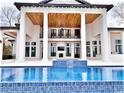 Stunning covered patio with wood ceiling, opening up to a beautiful pool with blue tile at 4110 Gray Heron Dr., North Myrtle Beach, SC 29582