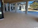 Expansive tiled patio with large support columns, offering a seamless indoor-outdoor living experience at 4300 Gray Heron Dr., North Myrtle Beach, SC 29582
