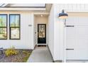 Inviting front entrance features modern black door with glass panel, adding curb appeal at 4363 Bayshore Dr., Little River, SC 29566