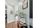 Bright hallway with wood floors leads to open living spaces; decorated with charming accents at 4363 Bayshore Dr., Little River, SC 29566