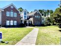 Charming two-story townhome featuring a well-kept lawn and inviting walkway leading to the entrance at 4394 Daphne Ln. # F, Murrells Inlet, SC 29576