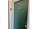Close-up of the front door, featuring a dark green finish, classic knocker, and secure lockset at 4394 Daphne Ln. # F, Murrells Inlet, SC 29576