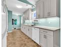 Bright kitchen featuring white cabinets, granite countertops, tile backsplash, and modern appliances at 454 Sean River Rd., Conway, SC 29526