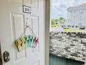 Welcoming condo entrance featuring a charming 'Welcome' flip-flop decoration and a glimpse of the community outside at 4783 Wild Iris Dr. # 101, Myrtle Beach, SC 29577