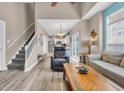 Open-concept living room with staircase, modern furniture, and bright natural light at 503 20Th Ave. N # 46 B, North Myrtle Beach, SC 29582