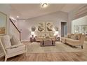 Bright living room boasts vaulted ceilings, wood floors, and comfortable seating, perfect for relaxation at 519 Magnolia Terrace Dr, Myrtle Beach, SC 29579