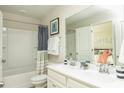 Well-lit bathroom featuring a double vanity, shower-tub combo, and calming neutral colors at 477 Magnolia Terrace Dr, Myrtle Beach, SC 29579