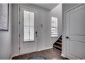 Bright foyer featuring a white door, hardwood floors, and staircase leading to upper level at 5406 Longhorn Dr., Myrtle Beach, SC 29588