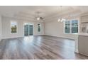 Spacious living room with hardwood floors, a tray ceiling, and lots of natural light at 61 Yale Pl., Pawleys Island, SC 29585