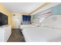 Comfortable bedroom featuring two beds, beach-themed decor, and ample lighting for a serene getaway at 6804 N Ocean Blvd. # 829, Myrtle Beach, SC 29572