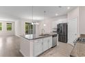 Spacious kitchen featuring an island, granite counters, and stainless steel appliances at 736 Flowering Branch Ave., Little River, SC 29566