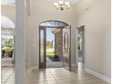 Bright and inviting foyer with arched doorway and detailed tile floors offering a glimpse of the exterior at 8204 Caddis Ct., Myrtle Beach, SC 29579