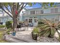 Backyard features a deck with a grill, seating, and lush greenery at 843 Villa Dr. # 843, North Myrtle Beach, SC 29582