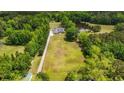 Aerial view of a home surrounded by mature trees and a tranquil pond at 856 W Highway 9, Longs, SC 29568