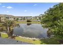 Scenic view overlooking the community pond surrounded by condos and trees at 8862 Duckview Dr. # E, Surfside Beach, SC 29575