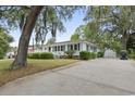 Inviting single-story home with a long drive and a detached garage at 908 Wood St., North Myrtle Beach, SC 29582