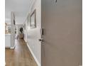Hallway leading into an open floor plan with hardwood floors and neutral paint colors at 9501 Shore Dr. # A-211, Myrtle Beach, SC 29572