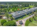 An aerial of the condos showcasing well-manicured grounds, a pond, and a golf course at 1001 World Tour Blvd. # 203, Myrtle Beach, SC 29579