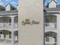 Close-up of 'The Cypress Point' sign on the building exterior, showcasing the property's name at 1001 World Tour Blvd. # 203, Myrtle Beach, SC 29579