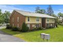 A two-story brick apartment building surrounded by lush green grass and mature trees at 1015 Elm St. # 4, Conway, SC 29526