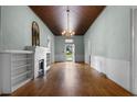 Spacious living room with hardwood floors, a fireplace, built-ins, and natural light at 118 Ford Ave, Mullins, SC 29574