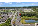 Aerial view of a condo complex near the water, featuring a scenic pond and mature trees at 1356 Glenns Bay Rd. # 202H, Myrtle Beach, SC 29575