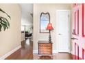 Inviting home foyer featuring hardwood floors, a red front door, and stylish mirror and table at 1367 Bermuda Grass Dr., Myrtle Beach, SC 29579