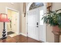 Bright foyer featuring a white front door with a glass panel and sidelight, plus tiled flooring at 1367 Bermuda Grass Dr., Myrtle Beach, SC 29579