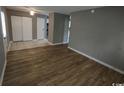 Spacious living room featuring modern wood flooring and neutral gray walls at 1432 Highway 544 # B2, Conway, SC 29526