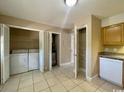 Functional laundry area with a washing machine, storage shelves, and extra cabinet space at 1432 Highway 544 # B7, Conway, SC 29526