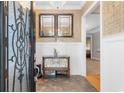 Elegant foyer featuring decorative tile flooring, patterned wallpaper, and decorative mirrors at 1516 James Island Ave., North Myrtle Beach, SC 29582