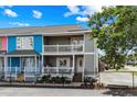 Charming two-story townhome with double balconies and a well-maintained, fenced yard at 2102 S Ocean Blvd. # D, North Myrtle Beach, SC 29582