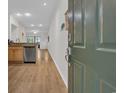 Open entryway showcasing wood-look floors, granite countertops, stainless steel appliances, and a view to the living area at 2103 Sweetwater Blvd. # 2103, Murrells Inlet, SC 29576