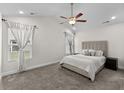 Light-filled main bedroom featuring a ceiling fan, carpeted floors and neutral tones at 224 Fishburn Dr., Conway, SC 29526