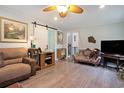 Comfortable living room with a decorative love seat, stylish barn door, and hardwood floors at 238 Robin Dr., Georgetown, SC 29440