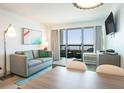 Comfortable living room with sofa and balcony with ocean views in this bright condo at 2401 S Ocean Blvd. # 557, Myrtle Beach, SC 29577