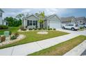 Landscaped front yard with lush green grass and decorative stone accents at 251 Juniata Loop, Little River, SC 29566