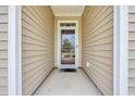 Covered entryway featuring neutral siding and a storm door, offering a welcoming entrance at 2757 Zenith Way, Myrtle Beach, SC 29577